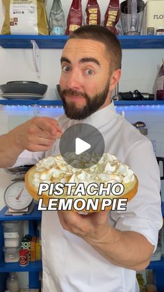 a man is holding a lemon pie in front of the camera