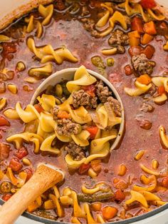 a pot filled with pasta and meat soup