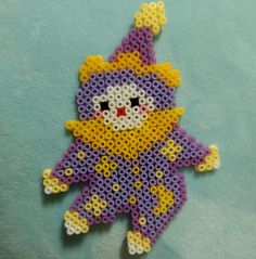 a purple and yellow beaded animal ornament