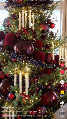 a christmas tree decorated with candles and ornaments