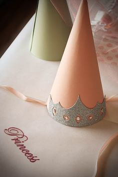 a pink and silver party hat sitting on top of a table