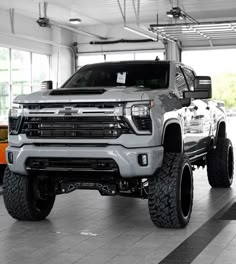 a silver truck is parked in a garage