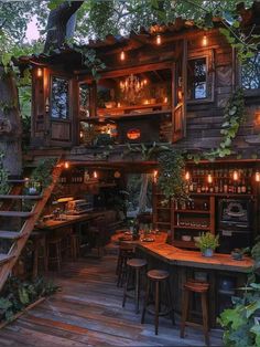 an outdoor bar is lit up with lights and greenery on the outside, along with stools