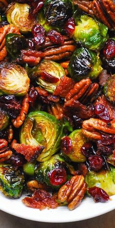 brussel sprouts with pecans and cranberries in a white bowl