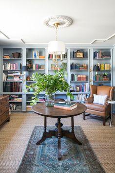 a living room filled with furniture and bookshelves covered in lots of bookcases