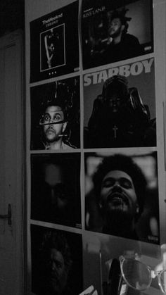 black and white photograph of various movie posters on the wall in a room with reading glasses