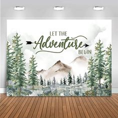 a wall hanging on the side of a wooden floor next to a painting with trees and mountains