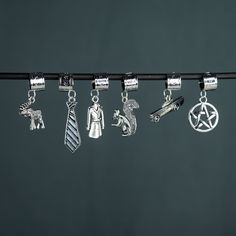 several charms are hanging on a black line