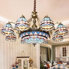 a chandelier hanging from the ceiling in a living room