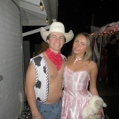 a man and woman dressed up as cowgirls posing for the camera at a party