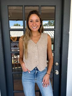 Elevate your style with The Cassy Top! Made with a ribbed stitch texture and featuring a v-neck, this versatile piece can be dressed up or down. With a button-down front closure, wear it over a tee or shirt for a layered look, or on its own for a chic statement. Perfect for daily casual wear. Gracie is wearing a size Small. Height is 5’11”, Bust is 32, Waist is 25”-26” Seamless V-neck Tank Top For Layering, Seamless Elastane V-neck Tank Top, Cotton V-neck Tank Top With Buttons, Taupe V-neck Summer Tops, Chic Taupe V-neck Top, Vintage Havana, Top Graphic Tees, Sweater Set, Layered Look