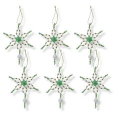 four green and white beaded snowflakes hanging from strings