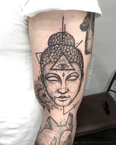 a woman's arm with a buddha tattoo on the left side of her body