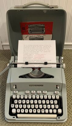 an old - fashioned typewriter is open and ready to be used as a display