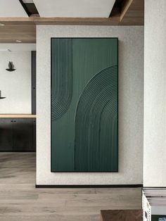 an abstract painting hangs on the wall next to a coffee table