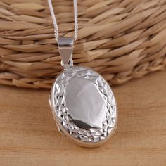 This is solid 925 sterling silver oval shape photo picture locket pendant.   925 stamped.    The locket is engraved on the front side and plain highly polished on the back.     Approx. pendant measures:            total length: 35mm           without bail: 26mm           width: 20mm    Approx. pendant only weight : 6.8gr.  Available on it's own or with various length (16-30Inch ) 1mm curb chain, please choose from the drop down menu at the top of the page.     Presented in gift box.     Thank yo Elegant Silver Locket Necklace Stamped 925, Oval Sterling Silver Locket Necklace With Polished Finish, Silver Locket Necklace With Polished Finish As Gift, Silver Oval Locket Necklace For Anniversary, Silver Polished Locket Necklace Gift, Silver Polished Locket Necklace For Gift, White Gold Sterling Silver Oval Pendant Locket Necklace, Oval White Gold Sterling Silver Locket Necklace, Sterling Silver Oval Pendant Locket Necklace For Keepsake