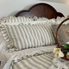 a basket with flowers sitting on top of a bed next to a pillow and blanket