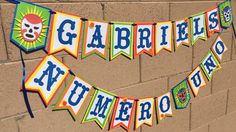 a banner on the side of a brick wall that says gabries and other decorations