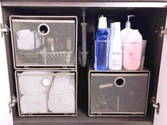 the bathroom cabinet is organized with toiletries and hand soaps