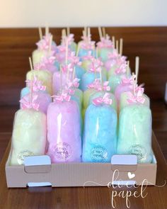 a box filled with different colored candles on top of a table