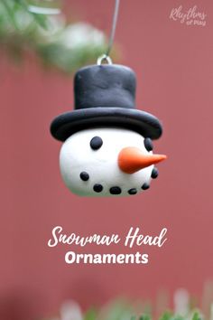 a snowman ornament hanging from a tree with the words snowman on it