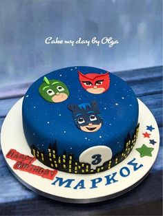 a birthday cake decorated with the characters of batman, robin and catwoman on it