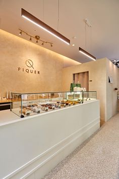 a display case in a bakery filled with pastries and desserts on top of white counter tops