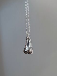 "A beautifully polished Argentium 940 solid silver tooth pendant, individually handmade by me at Ossia Obscure. It was sculpted and designed to scale of a real lower(jaw) human molar.  It hangs on a 24\" Sterling Silver 925 anchor chain and would look really striking on its own or to layer with other pieces of jewellery.  I aimed to combine a high quality piece of fine jewelry with a dark macabre/occult twist. I have a love for creating weird anatomical jewelry and teeth in particular are a favourite of mine. All designs are individually handmade by me in Argentium 940 Silver, a superior option to traditional Sterling 925 containing a higher percentage of silver. It has a brighter or whiter colour and has much greater tarnish and scratch resistance. It has been hallmarked in Dublin's Assay Anatomical Jewelry, Silver Tooth, Tooth Pendant, Alternative Jewelry, Tooth Necklace, Anchor Chain, Necklace Unique, Argentium Silver, Black Jewelry