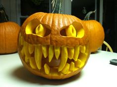 two pumpkins that have been carved to look like teeth