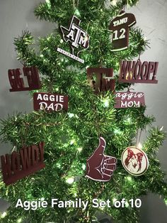 a christmas tree decorated with many different types of magnets and hand - made ornaments