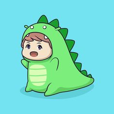 a little boy in a green dinosaur costume sitting on the ground with his head sticking out