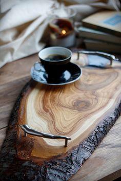 a cup of coffee sitting on top of a wooden tray