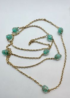 "Gorgeous Murano glass beaded opera length necklace.  The beads are turquoise aqua with gold swirls.  The necklace is 52\" long and can be worn as a single strand over the neck or doubled.  Nice heavy gold cable chain." Gold Turquoise Necklace With Faceted Beads As Gift, Turquoise Glass Necklaces For Party, Turquoise Glass Necklace For Party, Turquoise Glass Party Necklace, Vintage Gold Beaded Turquoise Necklace, Turquoise Wire Wrapped Glass Necklaces, Turquoise Glass Wire Wrapped Necklace, Turquoise Wire Wrapped Glass Necklace, Murano Glass Necklaces