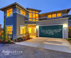 a large house with a lighted garage door