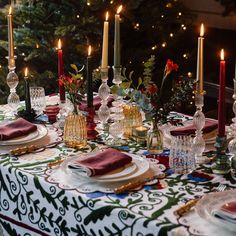 a table set with place settings and candles