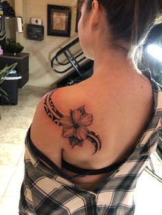 a woman with a flower tattoo on her shoulder