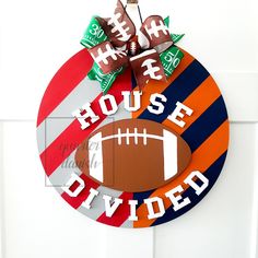 a football themed door hanger with the words house divided on it