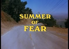 a road with the words summer of fear written in yellow on it's side