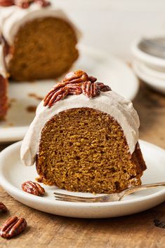 a slice of carrot bundt cake with frosting and pecans on the side