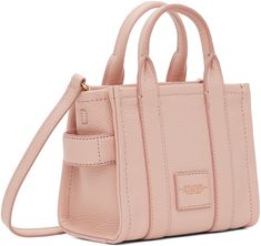 Grained leather tote in pink. Logo embossed at face. · Twin rolled carry handles at top · Detachable and adjustable shoulder strap · Carry handle at side · Logo patch at back face · Zip closure · Leather lining · Logo-engraved gold-tone hardware · H6 x W7 x D4 in Supplier color: Rose Pink Textured Leather Rectangular Bag, Pink Rectangular Textured Leather Bag, Pink Top Handle Bag With Textured Leather, Pink Textured Leather Top Handle Bag, Pink Textured Leather Bag For Daily Use, Pink Textured Leather Rectangular Shoulder Bag, Everyday Pink Textured Leather Bag, Pink Textured Leather Shoulder Bag, Pink Textured Leather Shoulder Bag For Travel