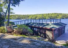 a boat dock sits on the shore of a lake with stairs leading up to it