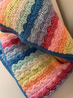 a multicolored crocheted blanket sitting on top of a counter