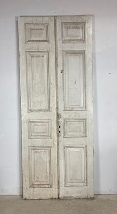 an old white double door in a room