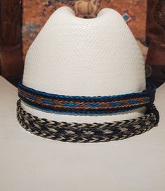 5 Strand Braided Horsehair Adjustable Wide Hat Band with 2 sliding knots that make this hatband a great fit for most hats. - Available in 10 colors:  Mixes of Turquoise Blue/Brown/Tan/White/Grey/Black - This stunning hat band is made from genuine braided horse hair and will compliment your favorite cowboy hat.   - 5 braided strands are sewn together to create this gorgeous hatband. - Hat band measurements: approximately adjusts to 27" around and is 3/4 inch wide - Hat bands are shown on a size 7 hat.  Hats are not included. - See my other HORSE HAIR hat bands:  https://www.etsy.com/shop/BlueEyesDesignsHB?ref=shop-header-name&listing_id=1296906619&from_page=listing&section_id=50325232 - See my LEATHER hat bands:  https://www.etsy.com/shop/BlueEyesDesignsHB?ref=shop-header-name&listing_id=12 Horse Hair Hat Band, Horse Hair Braiding, 5 Strand Braids, Wide Hat, Hair Hat, Hat Bands, Horse Tail, Leather Hat, Black Turquoise