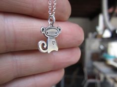 Monkey loves you. This playful little guy measures 1/2 of an inch tall, is made using solid sterling silver, and comes on the chain length and style you choose from the drop down menu. To see the larger version: http://www.etsy.com/listing/94279571/monkey To see the mother-daughter set: http://www.etsy.com/listing/94275656/mother-daughter-monkey-necklace-set And the matching earrings: http://www.etsy.com/listing/94587376/little-monkey-earrings Items are shipped as a gift without a receipt in a c Playful Silver Charm Necklaces, Playful Adjustable Silver Charm Necklace, Adjustable Delicate Sterling Silver Charm Necklace, Cute Silver Charm Necklaces As Best Friend Gift, Cute Silver Charm Necklaces For Best Friend Gift, Monkey Earrings, Monkey Necklace, Tiny Monkey, Cute Box