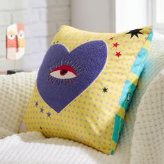 a pillow with an eye and stars on it