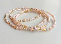 For discounted prices, please visit our website: https://www.ghanatreasures.com Custom made: peachy pink glass beads and genuine fresh water pearls. You can also wrap them around your wrist , neck or ankle. If you don't find your size, please leave a note. What are the benefits of freshwater pearl? Some healers use Freshwater cultured pearls to balance hormone levels and bodily rhythms with lunar cycles. The inner radiance (orient) of Freshwater cultured pearls is believed to cultivate love and tap into consciousness. Freshwater cultured pearls are also thought to represent purity and faith. SHIPPING AND TRACKING: PLEASE READ OUR SHOP ANNOUNCEMENT. These beautiful waist beads, very thin, are traditionally worn in Africa by women and girls usually in a set of 3.  When choosing your size, pl Pink Waist Beads, Ideas For Bracelets, African Traditions, Beads Bracelet Design, Waist Beads, Hormone Levels, Fresh Water Pearls, Belly Chain, Bracelet Design