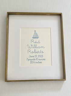 a white and gold frame with a blue sailboat on it's back side