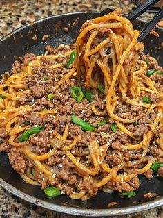 a close up of a plate of food with noodles and ground beef on the side