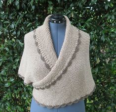 A 100% soft acrylic hand-knit triangle shawl, inspired by Brianna's shawl in Outlander.  It is very light beige (grand canyon) for the shawl, and taupe crochet on the edge of the shawl.  It is perfect for size M-L, and will work for size S and XL with a different look. The shawl is super soft and comfortable.  The pictures shown were taken on a "L" size mannequin. The wrap measures 67 inches tip to tip, 35 inches from center back top to bottom tip, and weighs 16 ounces.  The shawl has a cord in Beige Wrap Shawl For Winter, Hand Knitted Beige Shawl For Winter, Hand Knitted Beige Winter Shawl, Cream Knitted Shawl One Size, One Size Cream Knitted Shawl, Cream Knitted One Size Shawl, Beige Wrap Shawl One Size, One Size Beige Wrap Shawl, Beige Wrap Shawl